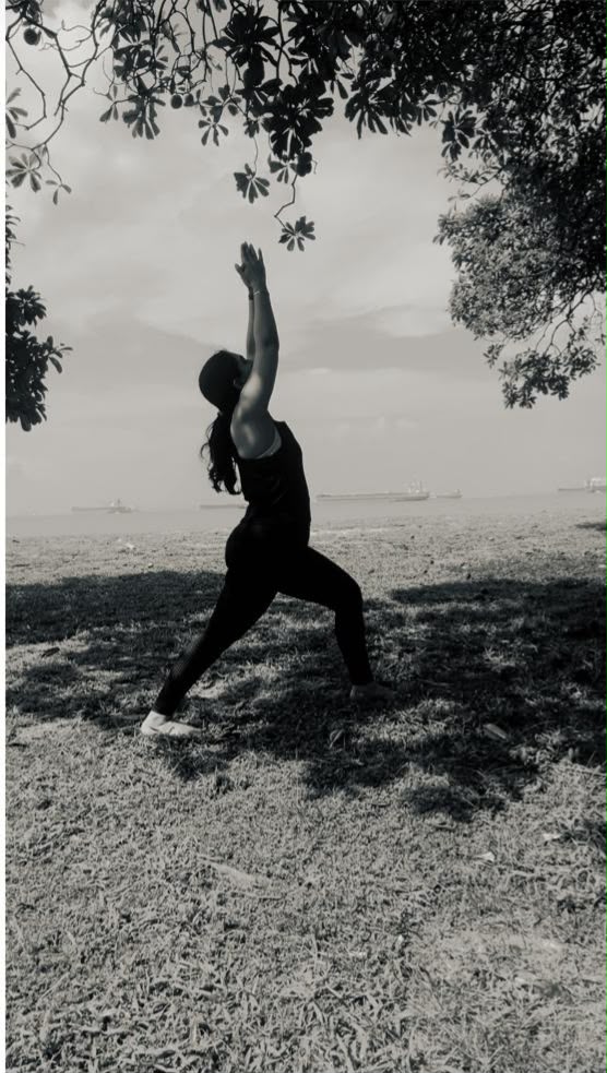 Karuna Grover in warrior pose, seaside, Singapore